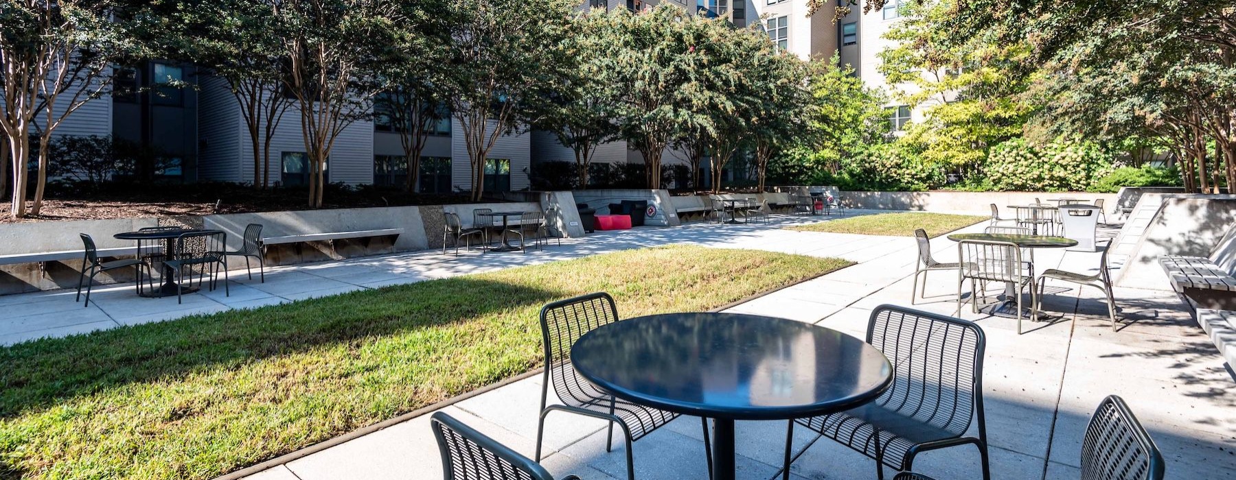 a courtyard with tables and chairs