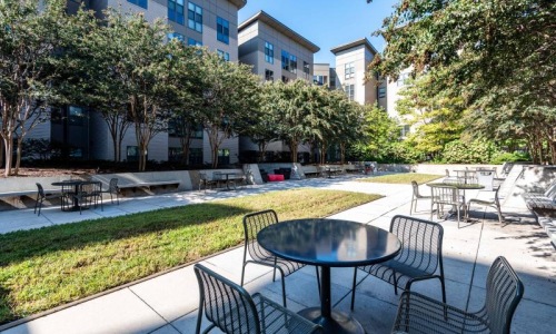 a courtyard with tables and chairs