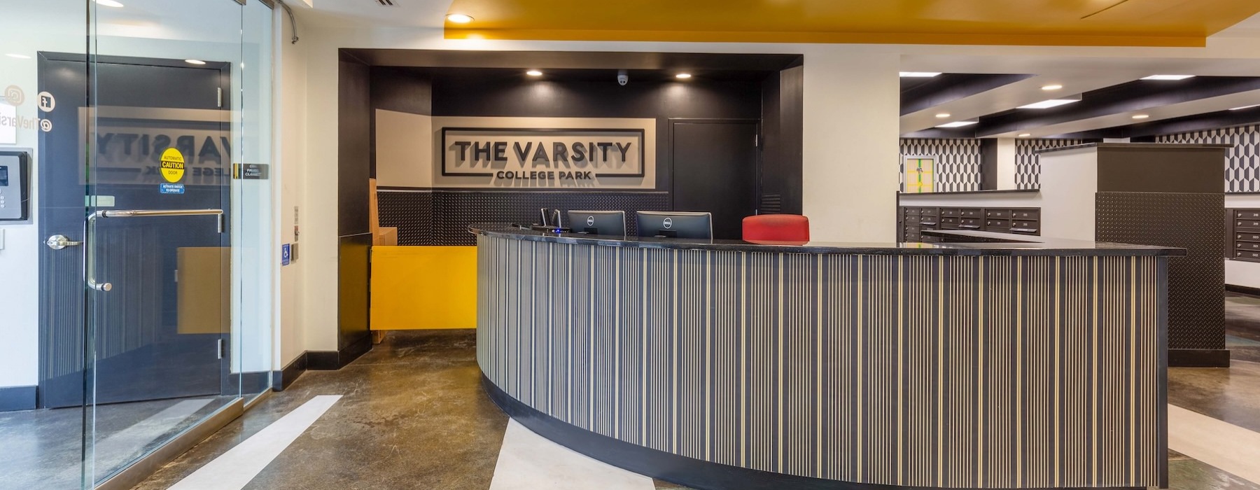 a lobby with a desk area and a sign